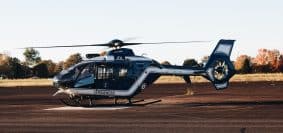 a helicopter sitting on top of an airport tarmac